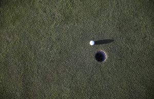 golf ball nearing hole