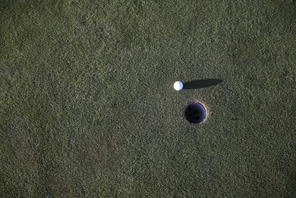 golf ball nearing hole